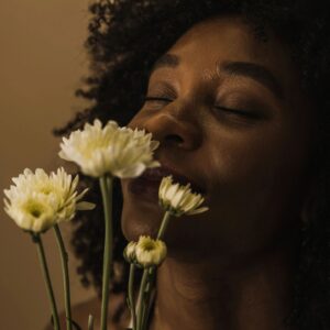 image of woman smelling flowers